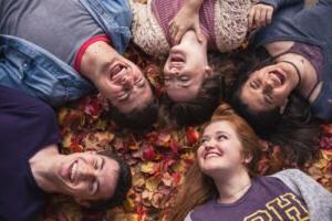 Picture of Students laughing in leaves